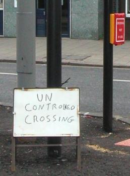 `UN CONTROLLED CROSSING' sign 